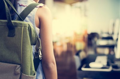 blurry view of child with backpack