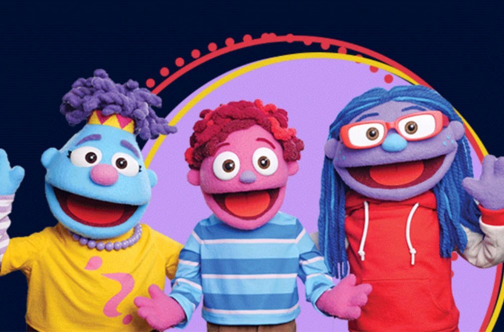 three puppets smile and hold out their hands