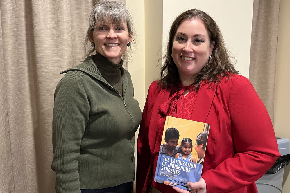 Anne Gebelein, left, and Rebecca Campbell-Montalvo gather after the event last month that celebrated Campbell-Montalvo's new book. (Shawn Kornegay/Neag School) 