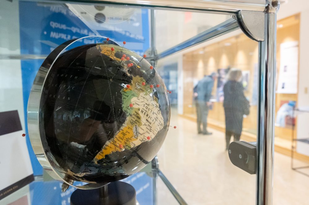 A globe signalling Pandemic Journaling Project participants' 55 countries of origin was on display at PJP's Picturing the Pandemic exhibition (https://picturingthepandemic.org/), which opened at the Hartford Public Library on Oct. 27, 2022. From Hartford, the exhibition continued on to Providence, Rhode Island; Heidelberg, Germany; Mexico City, Mexico; and Toronto, Canada. (Sydney Herdle/UConn Photo)